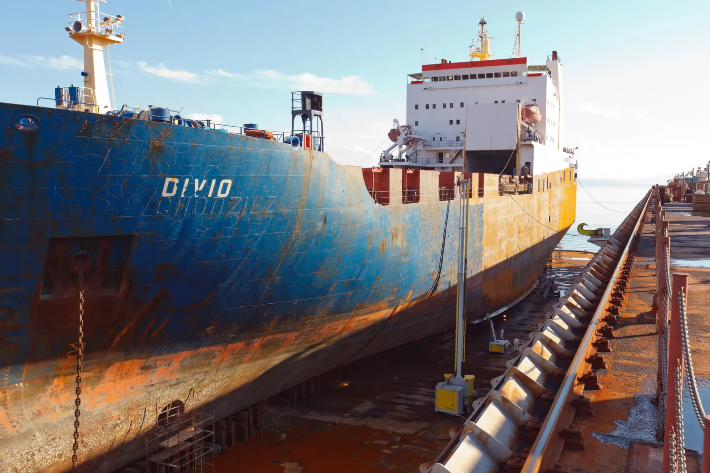 Ship in dry dock during hull preparation with Hammelmann water-jetting equipment