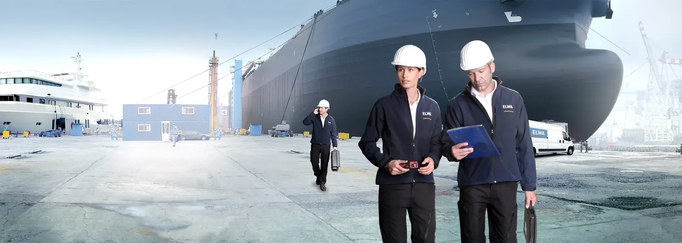 ELWA engineers at a shipyard in front of a tanker